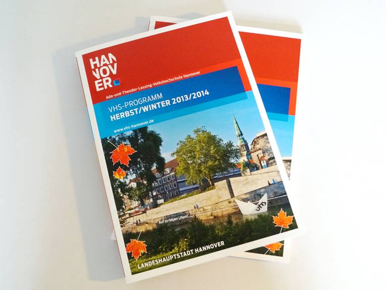 Zwei Exemplare des VHS-Programms für den Herbst/Winter 2013/2014 auf einem grauen Tisch