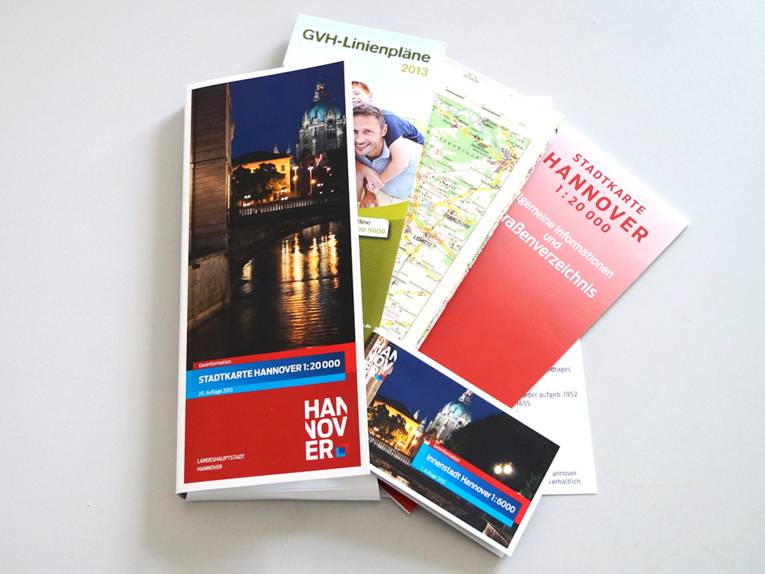 Foto der neuen hannoverschen Stadtkarte, zu sehen ist das Innenleben: Die Karte selbst, ein Straßenverzeichnis, ein GVH-Linienplan und eine Detailkarte der Innenstadt