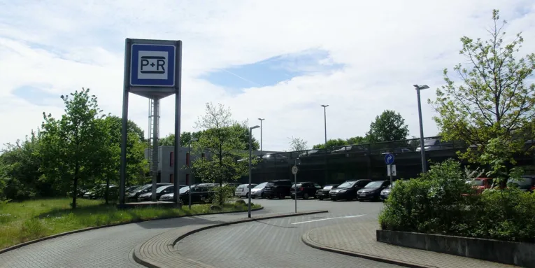 Parkplatz und Parkhaus mit parkenden Autos