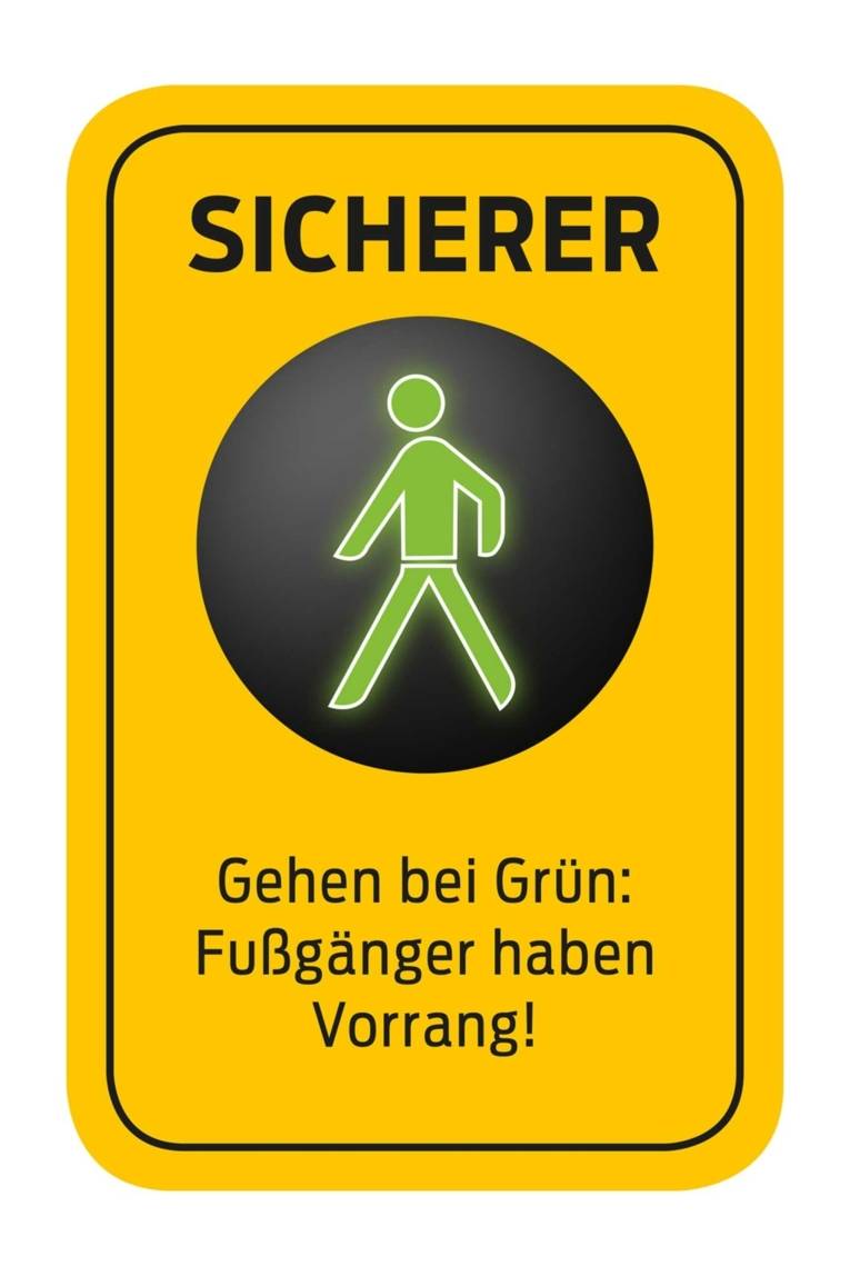 Ein Piktogramm mit folgendem Text: "SICHERER - Gehen bei Grün: Fußgänger haben Vorrang"