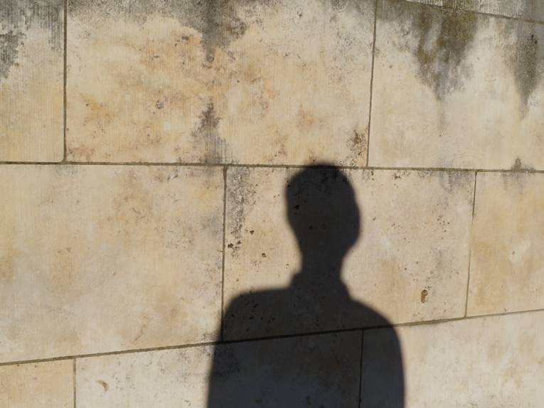 Ein menschlicher Schatten an einer Mauer