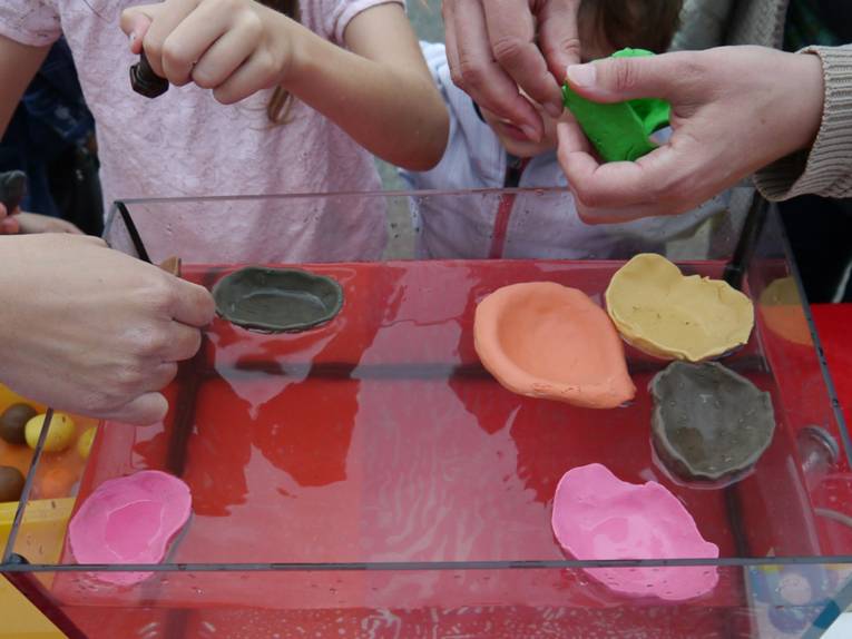 In einem kleinen Wasserbecken schwimmen selbstgemachte Untersetzer aus Knete.