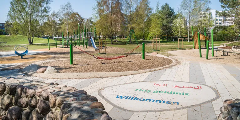 Ein Stadtteilpark mit Spielgeräten.
