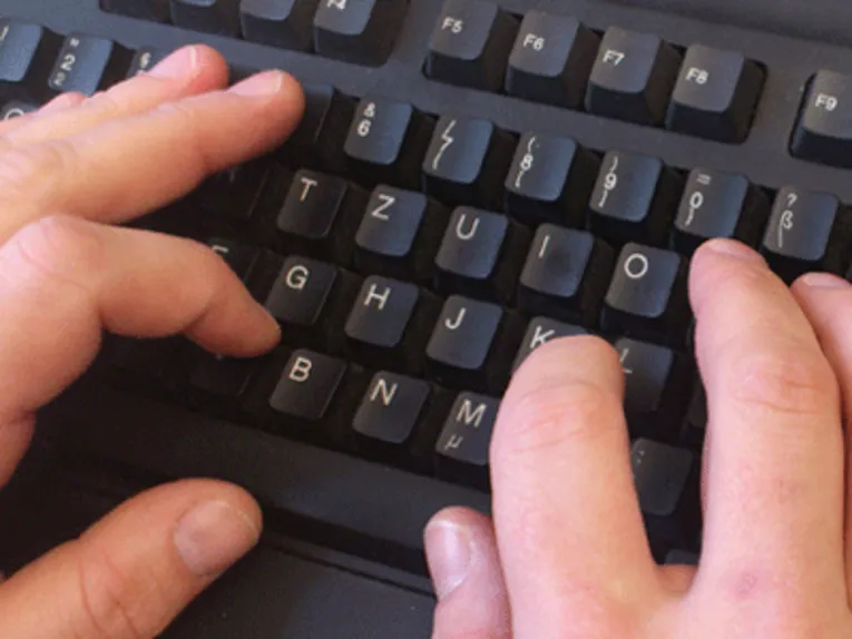 Hände auf einer Tastatur.