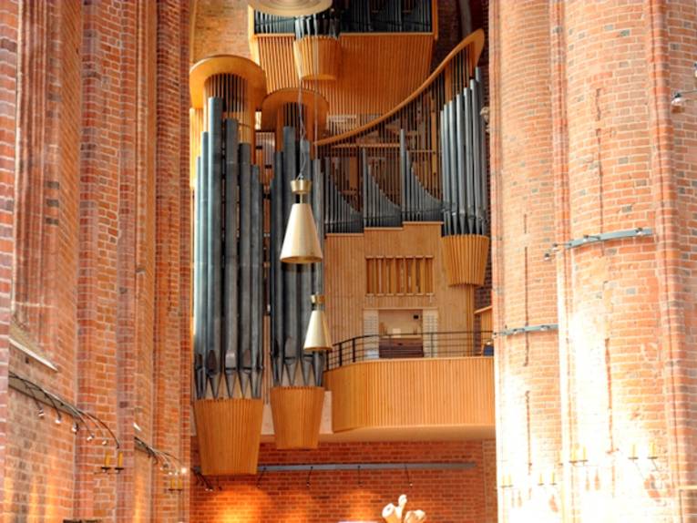 An large organ in a brick church.
