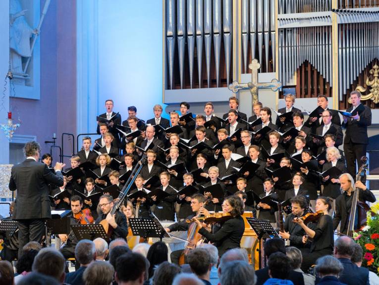 Knabenchor mit Orchestermusikern bei einem Konzert in einer Kirche