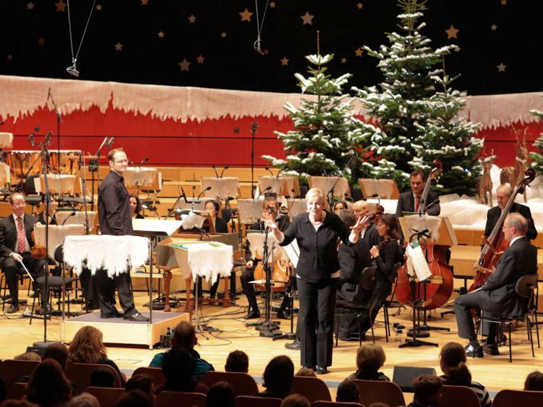 Orchestermusiker auf weihnachtlich geschmückter Bühne