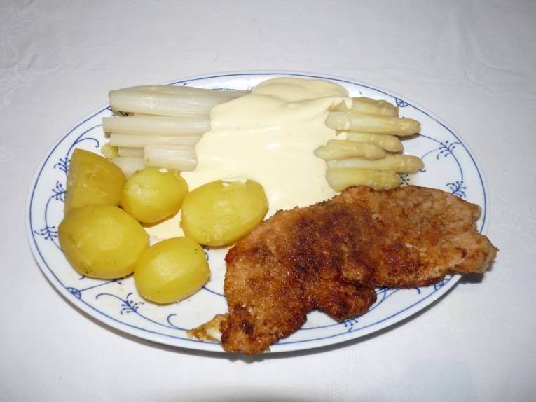 Teller mit Kartoffeln, Spargel mit Soße und Schnitzel