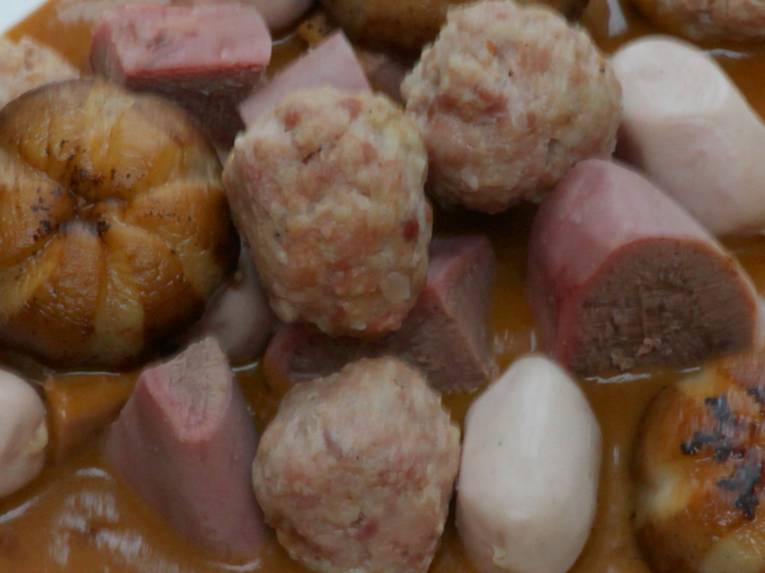 Teller mit Fleischstücken, Fleischkklößen und Soße