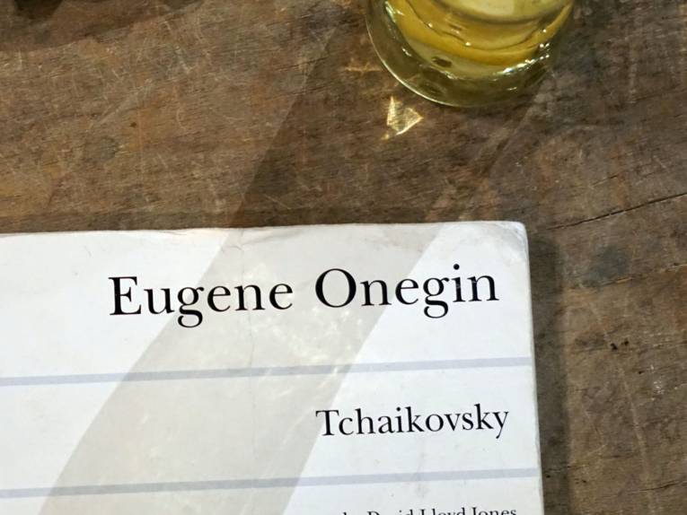 Papier mit der Aufschrift Eugen Onegin und Tchaikovsky auf Holzunterlage.