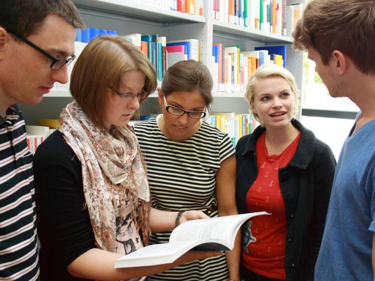 Menschen vor einem Regal mit Büchern