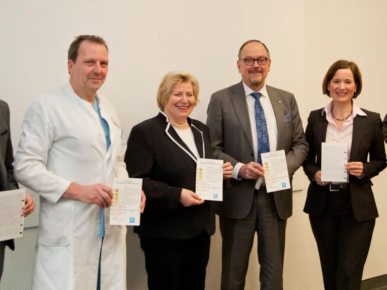 Menschen einen Zettel in die Kamera haltend