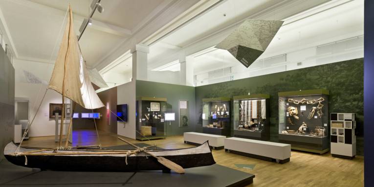 Raum mit Vitrinen und einem Auslegerboot mit Segel
