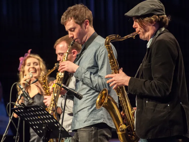 Musiker spielen ihre Instrumente, darunter Saxophone.
