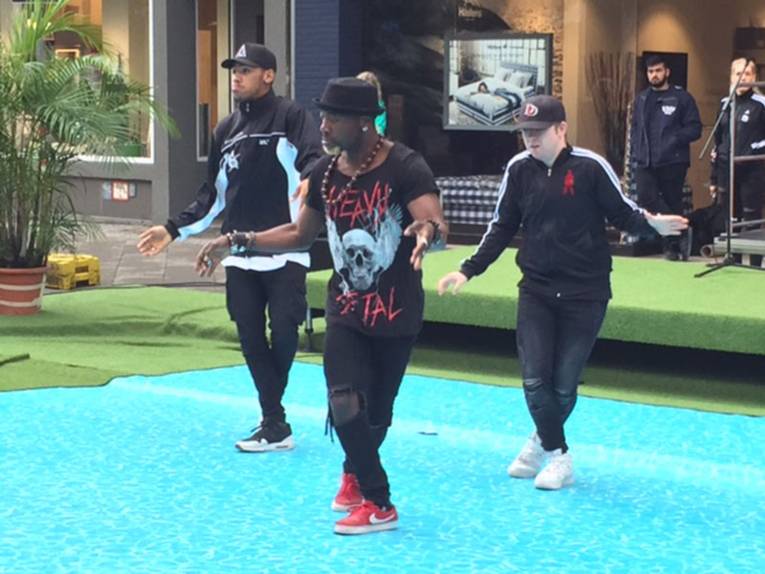 Drei Tänzer auf einer Bühne