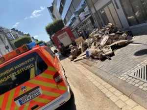Ein Auto der Feuerwehr Hannover und ein Auto der Feuerwehr Euskirchen vor zerst&ouml;rtem Mobiliar